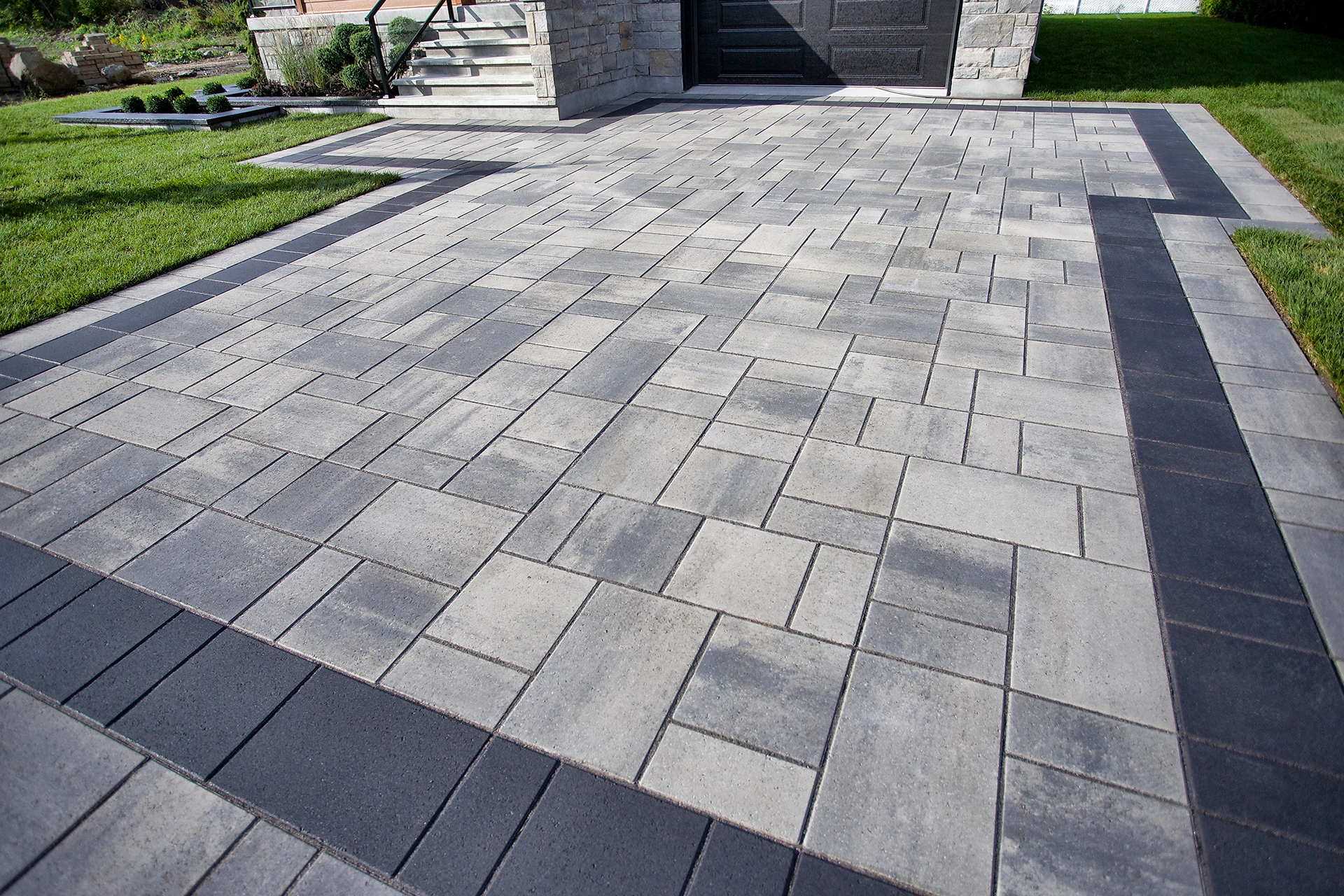 Interlocking driveway pavers installed by Patios Dallas in residential driveway
