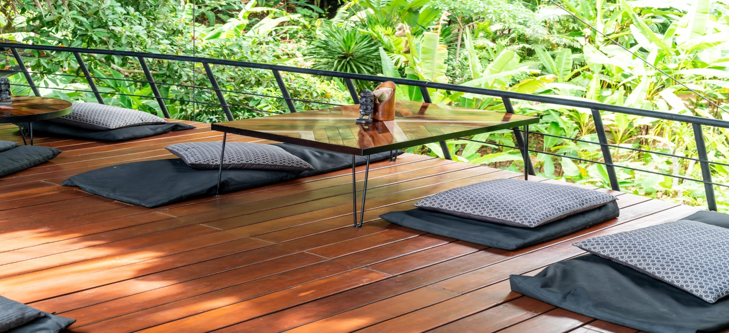 Covered backyard deck with outdoor dining area built by Patios Dallas